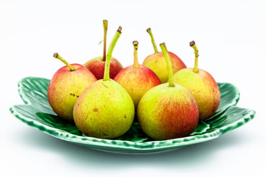 Lots of little ripe pears on white background