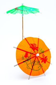 Two cocktail umbrellas on a white background