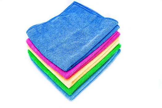 Stacked colorful towels on a white background