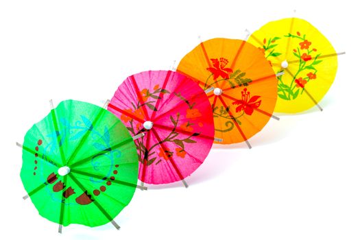 Several cocktail umbrellas on a white background