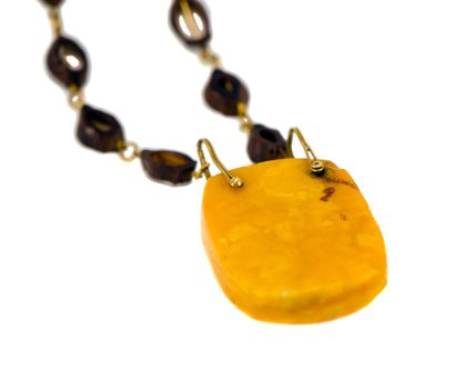 Big amber stone necklace isolated on white background. Closeup of luxury apparel.