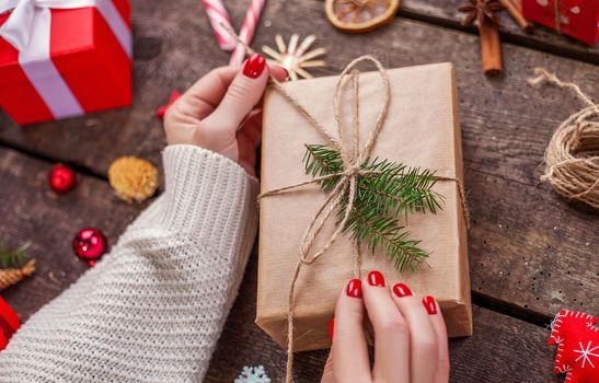 Gift box in wrapping paper with satin ribbon. Merry Christmas holiday concept.