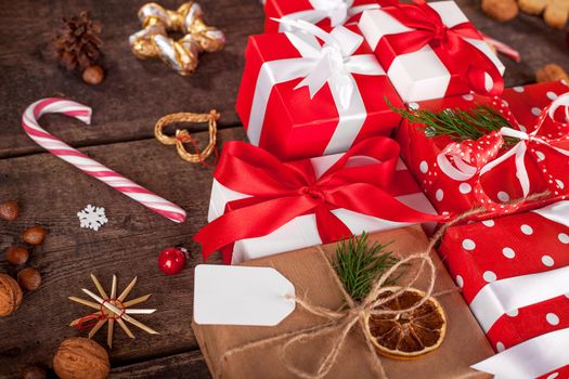 Gift box in wrapping paper with satin ribbon. Merry Christmas holiday concept.