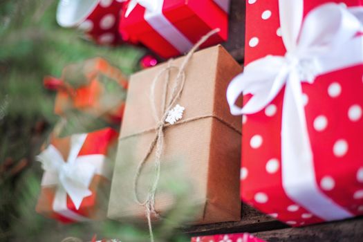 Gift box in wrapping paper with satin ribbon. Merry Christmas holiday concept.