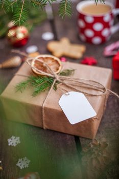 Gift box in wrapping paper with satin ribbon. Merry Christmas holiday concept.