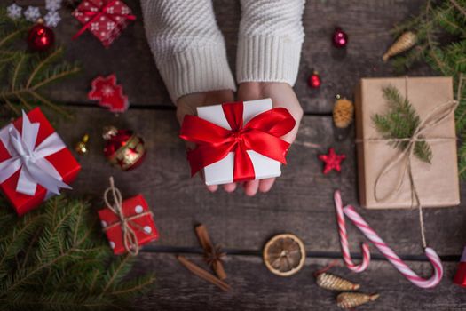 Gift box in wrapping paper with satin ribbon. Merry Christmas holiday concept.