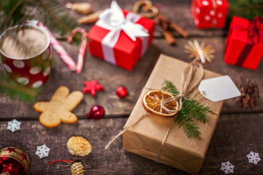 Gift box in wrapping paper with satin ribbon. Merry Christmas holiday concept.