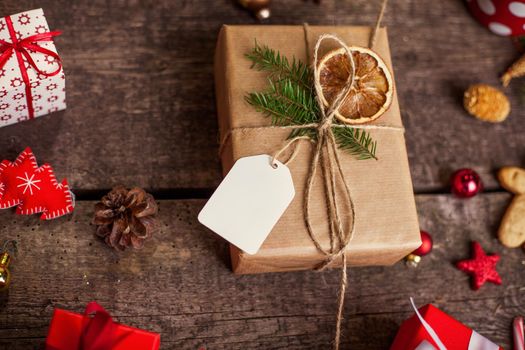 Gift box in wrapping paper with satin ribbon. Merry Christmas holiday concept.