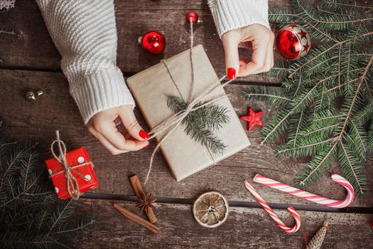 Gift box in wrapping paper with satin ribbon. Merry Christmas holiday concept.