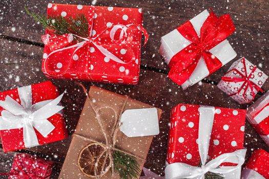 Gift box in wrapping paper with satin ribbon. Merry Christmas holiday concept.