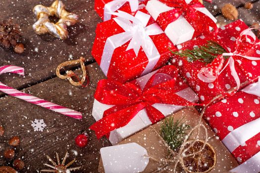 Gift box in wrapping paper with satin ribbon. Merry Christmas holiday concept.