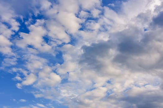 blue sky background with cumulus white clouds.