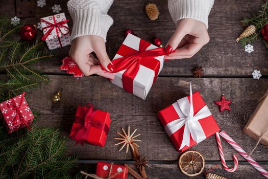 Gift box in wrapping paper with satin ribbon. Merry Christmas holiday concept.
