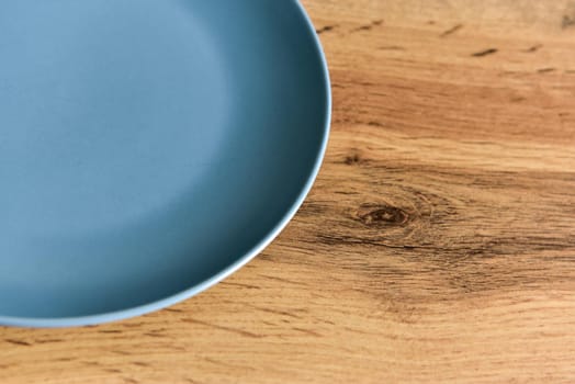 Close-up of empty plate on wooden background with copy space.