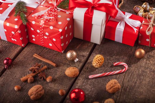 Gift box in wrapping paper with satin ribbon. Merry Christmas holiday concept.
