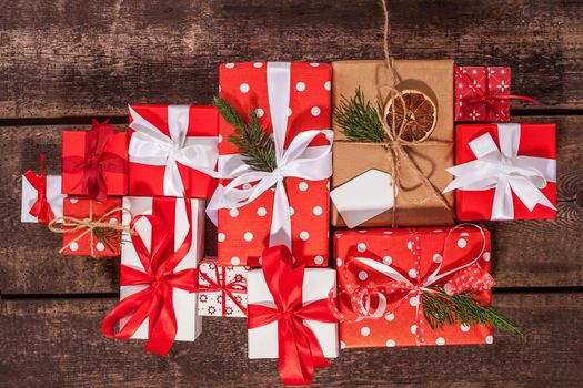 Gift box in wrapping paper with satin ribbon. Merry Christmas holiday concept.