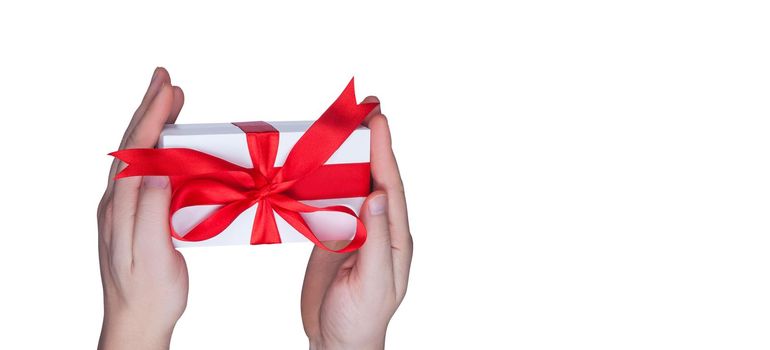 Gift box in wrapping paper with satin ribbon. Merry Christmas holiday concept.
