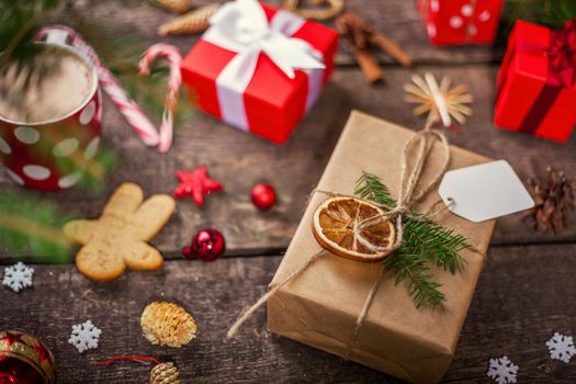 Gift box in wrapping paper with satin ribbon. Merry Christmas holiday concept.