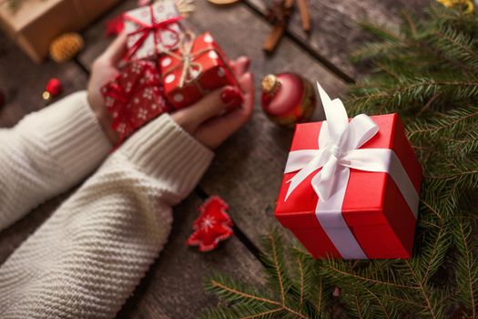 Gift box in wrapping paper with satin ribbon. Merry Christmas holiday concept.