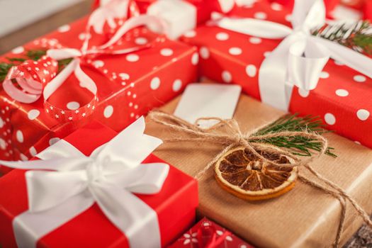 Gift box in wrapping paper with satin ribbon. Merry Christmas holiday concept.