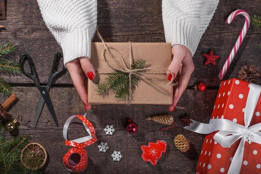 Gift box in wrapping paper with satin ribbon. Merry Christmas holiday concept.