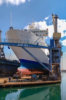 Chernomorsk, Ukraine. 21.03.2021. Large ship in dry dock of the Chernomorsk Shipyard on a sunny spring day