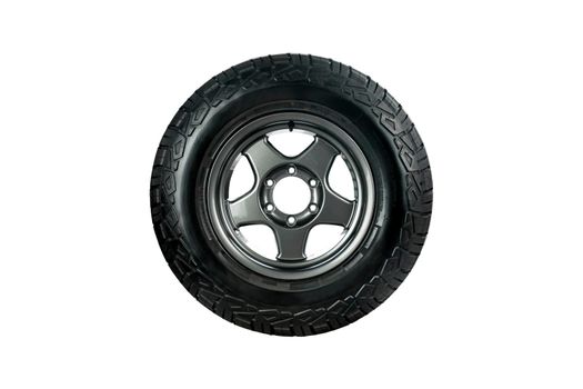 All terrain tire designed for use in all road conditions with alloy wheel isolated on white background.