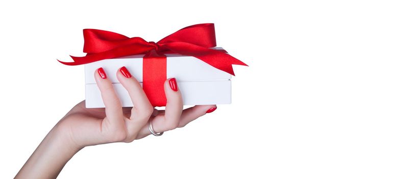 Gift box in wrapping paper with satin ribbon. Merry Christmas holiday concept.
