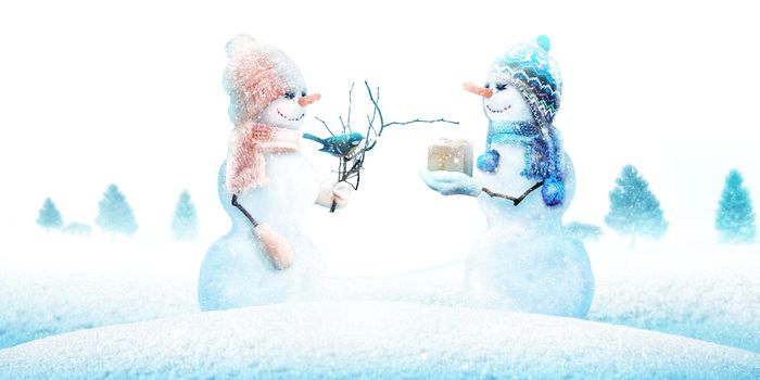 Happy snowman standing in winter christmas landscape.