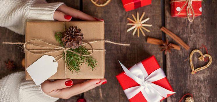 Gift box in wrapping paper with satin ribbon. Merry Christmas holiday concept.
