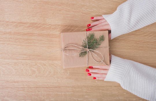 Gift box in wrapping paper with satin ribbon. Merry Christmas holiday concept.