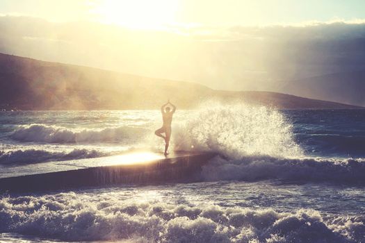 Feeling of freedom concept. Man standing on pier facing to the sea with big waves.