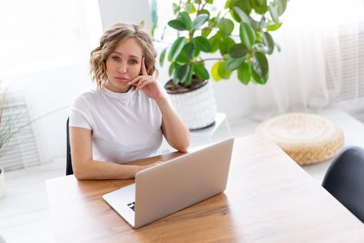 Business woman using laptop sitting near desk white office interior with houseplant looking at camera Business people Business person Online, Young and successful Dresed white shirt