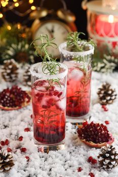 Glass with pomegranate Margarita with candied cranberries, rosemary. Perfect cocktail for a Christmas party