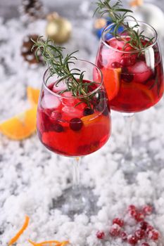 Cocktail Margarita with cranberries, orange and rosemary. A perfect cocktail for a Christmas party