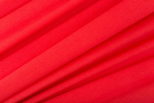 Abstract red background with diagonal lines. Red textured background with waves made of corrugated paper. Concept of template for advertising or banner with copy space