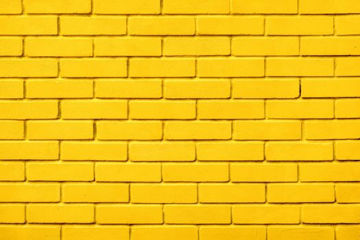 Block texture yellow painted wall brick background warm color. Painted bricks design yellow color wall background blocks. Natural design texture background yellow brick wall color paint block pattern