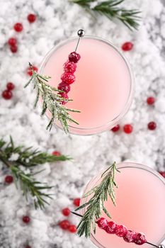 Goblet with cranberry Margarita with candied cranberries, rosemary. Perfect cocktail for a Christmas party