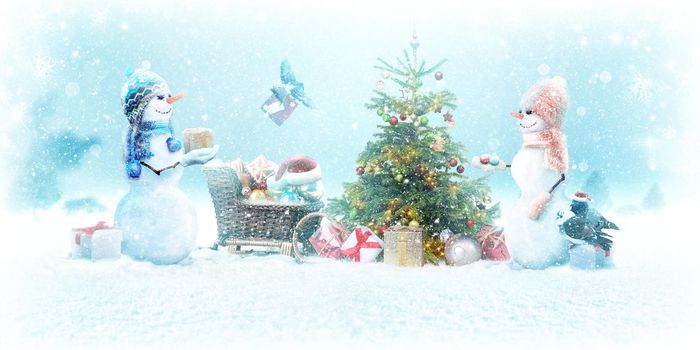 Happy snowman standing in winter christmas landscape.