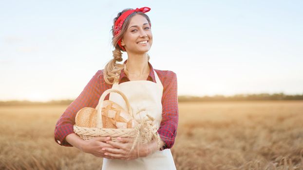 Female farmer standing wheat agricultural field Woman baker holding wicker basket bread eco product Baking small business Caucasian person dressed red checkered shirt apron organic healthy food