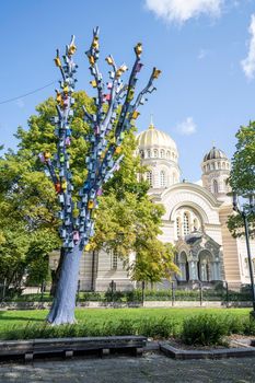 Riga, Latvia. August 2021.  a colorful tree with many birdhouses in a city center par