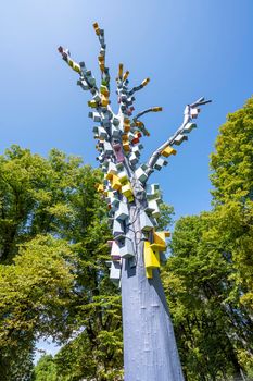 Riga, Latvia. August 2021.  a colorful tree with many birdhouses in a city center par