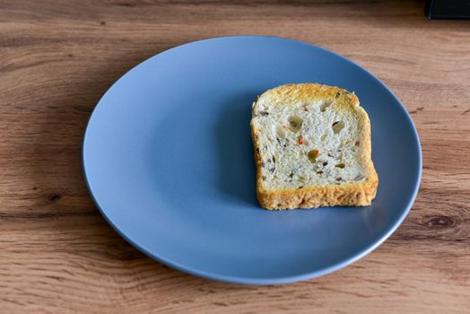 Toast bread in a plate on vintage wooden background.