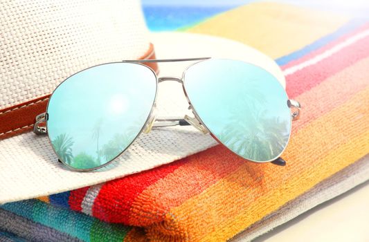 Summer vacation concept. Sunglasses with ocean beach and palms.