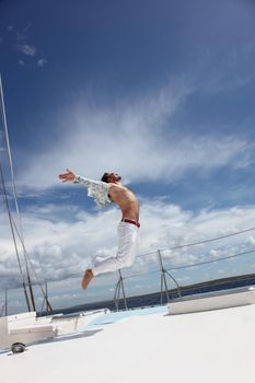 Man enjoying summer time holiday on sailing boat.