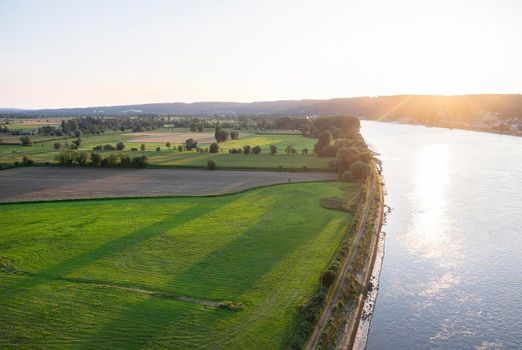 sunset over landscape of regional park boucles de la seine and river seen from pont de brotonne in france