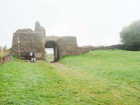 Main entrance into rest of ruin of stronghold  Lichnice in heavy fog and cloudy rainy day. Czechia travel.