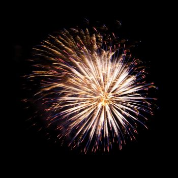 Colorful celebration fireworks isolated on a black sky background.