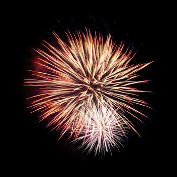 Colorful celebration fireworks isolated on a black sky background.