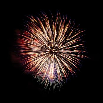 Colorful celebration fireworks isolated on a black sky background.